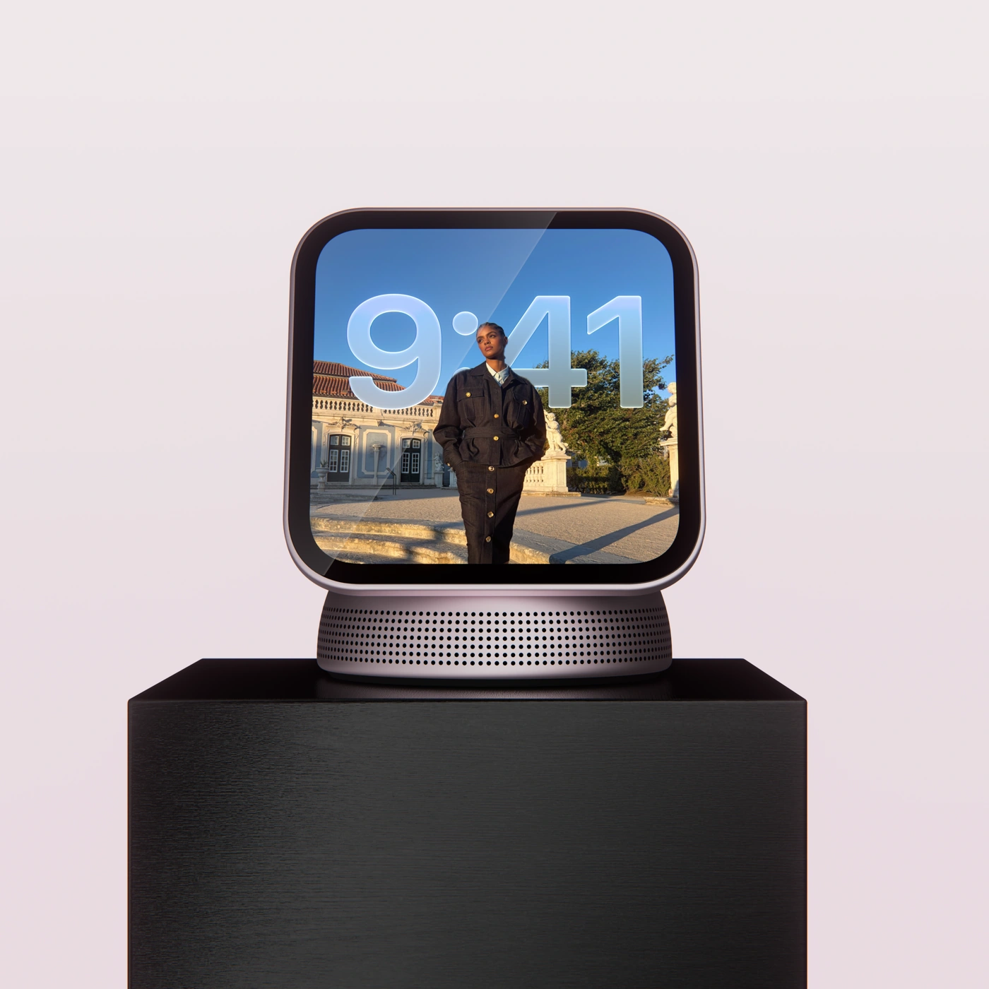 Front view of a Home Hub display showing a photo and clock, on a perforated speaker base and wooden pedestal
